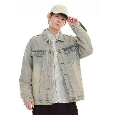 Teen male model wearing a loose fit American retro washed denim jacket in yellow mud gray with side seam pockets and regular sleeves.
